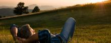 man relaxing in a peaceful field 