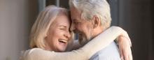 man and woman hugging and laughing
