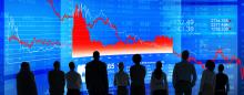 silhouettes of people watching a downward trending graph